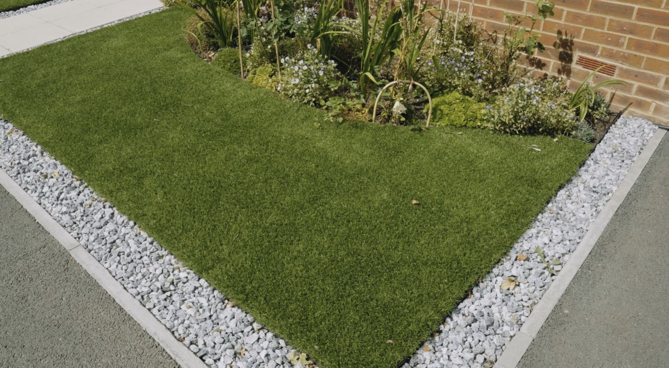 Commercial artificial grass installation with professional edging